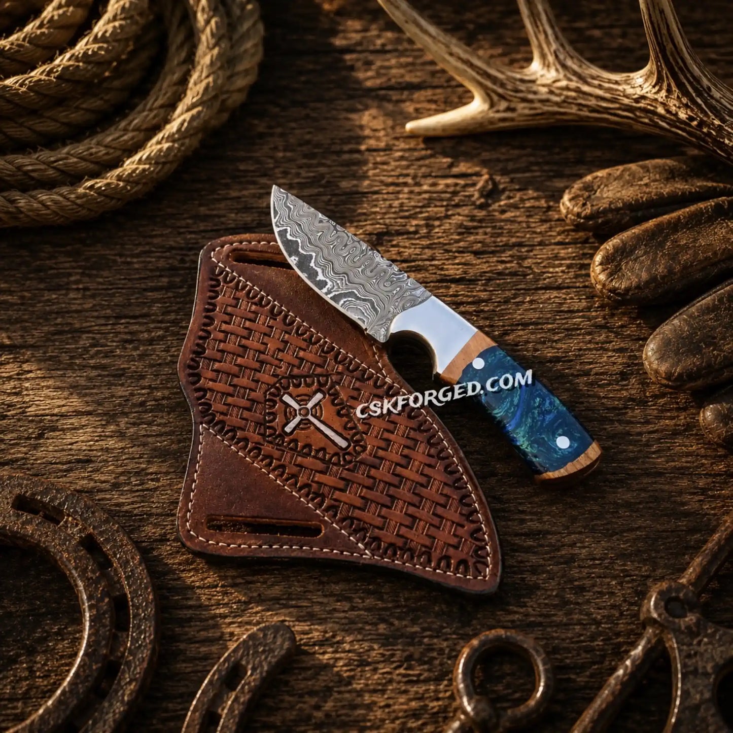 Cowboy hunting knife with 4-inch Damascus steel blade and blue epoxy resin handle with hand-tooled leather belt sheath