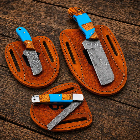 Custom Damascus steel bull cutter knives displayed on handmade pancake leather sheaths