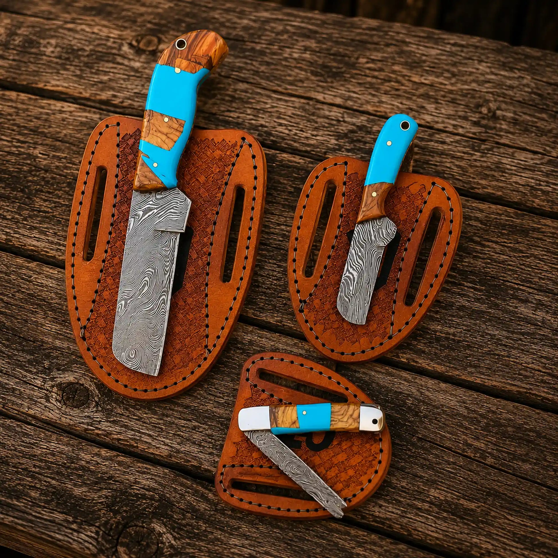 Handmade Damascus steel bull cutter knife set with turquoise resin handles and pancake sheaths.