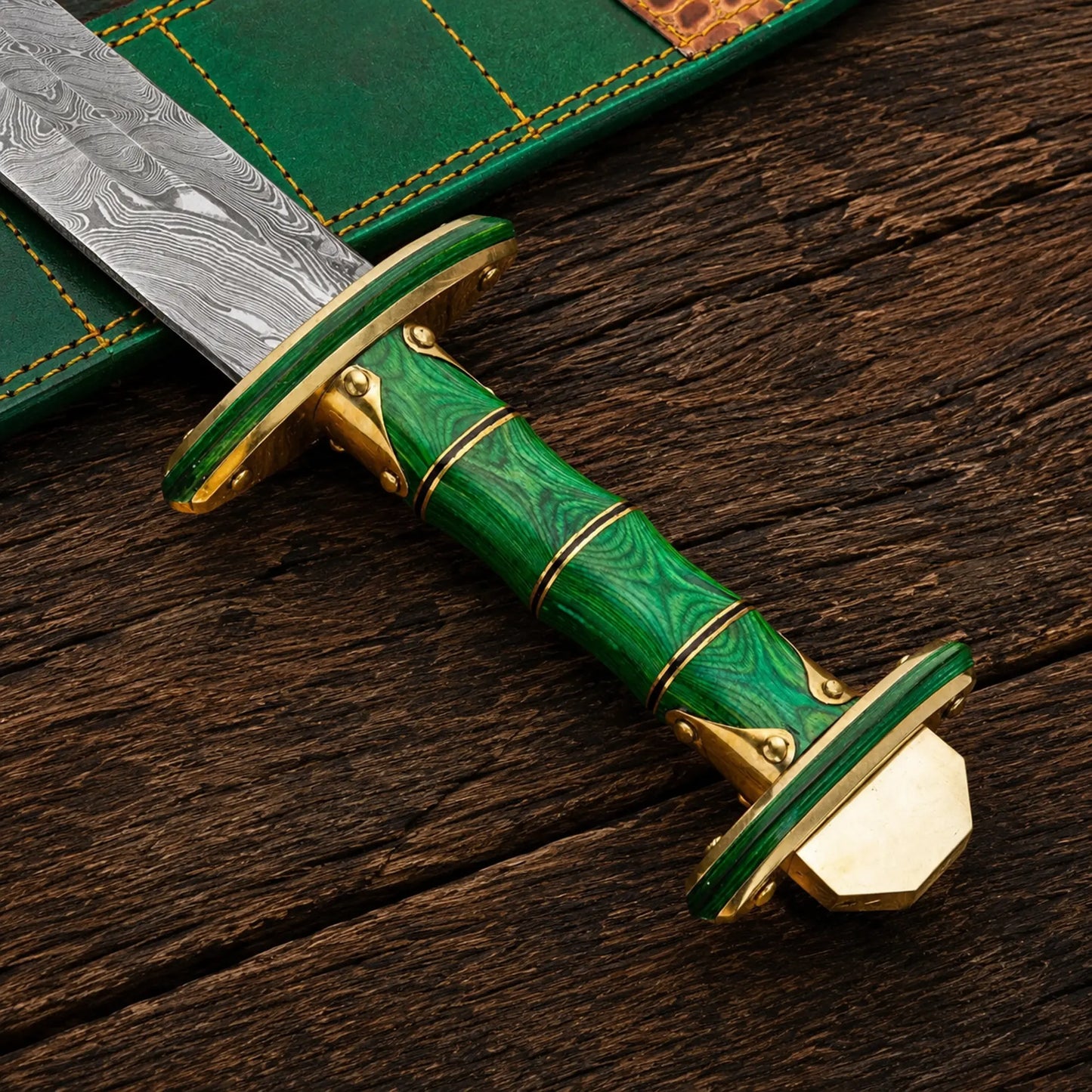 Handmade Damascus steel Viking sword featuring green Pakka wood handle and brass fittings.