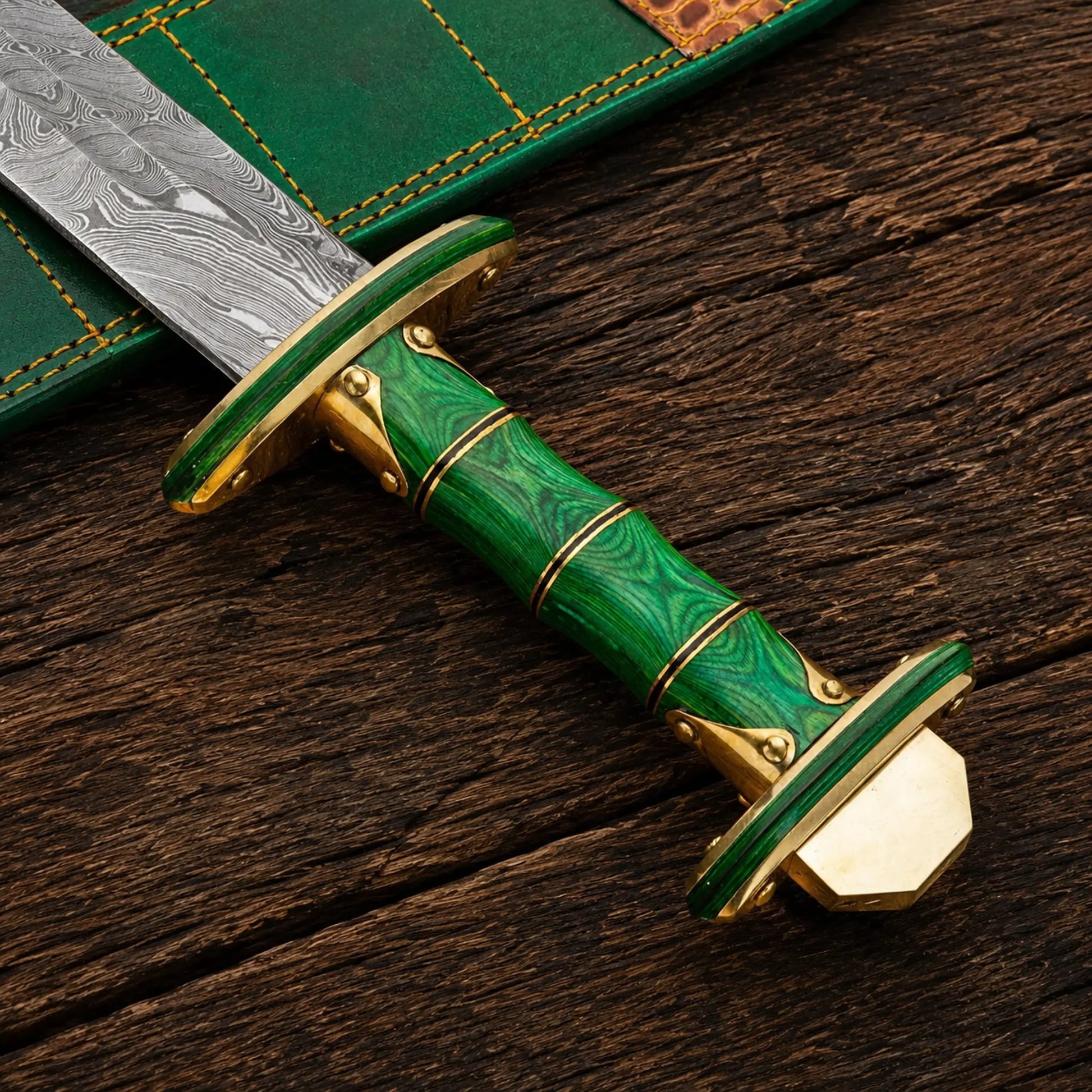 Handmade Damascus steel Viking sword featuring green Pakka wood handle and brass fittings.