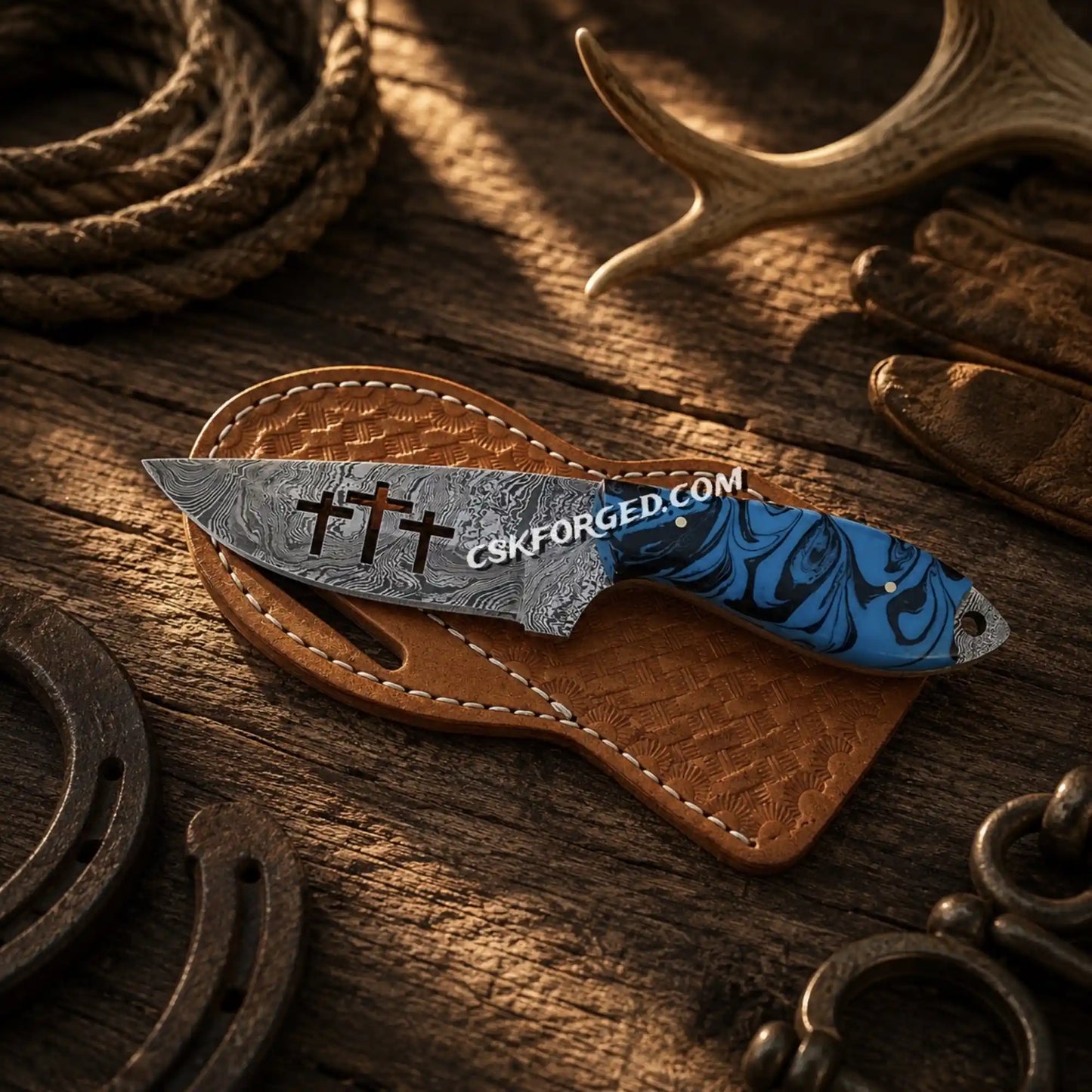 Trio Cross cowboy hunting knife with 4 inch Damascus blade and blue resin handle with cross-side leather belt sheath